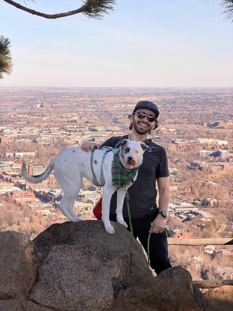 Kyle and his dog at a mountain overlook